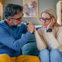 Middle aged man and woman on couch