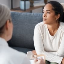 Woman sitting on couch looking away