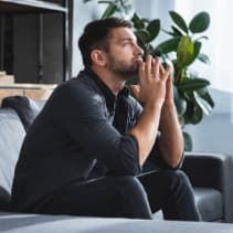 man sitting wistfully