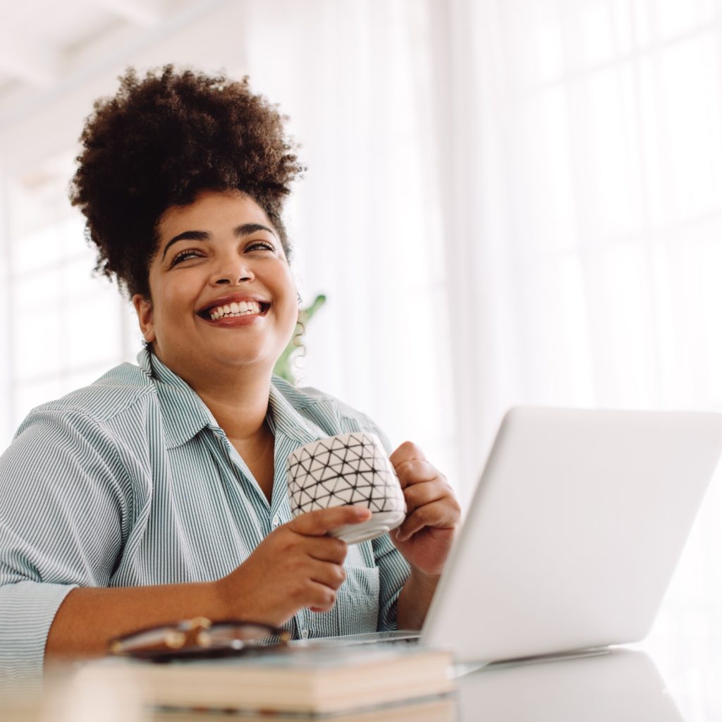 Woman smiling at laptop