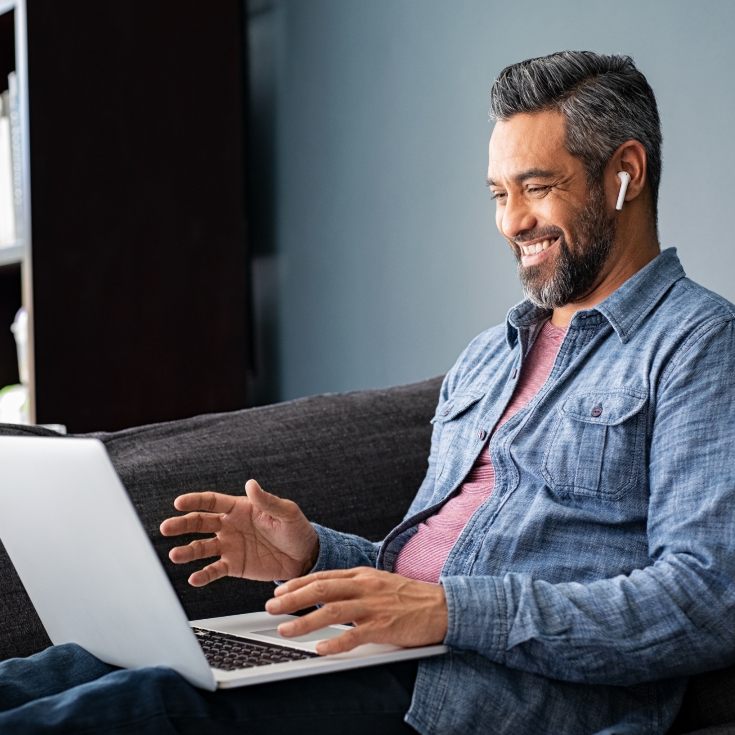 Man smiling at laptop